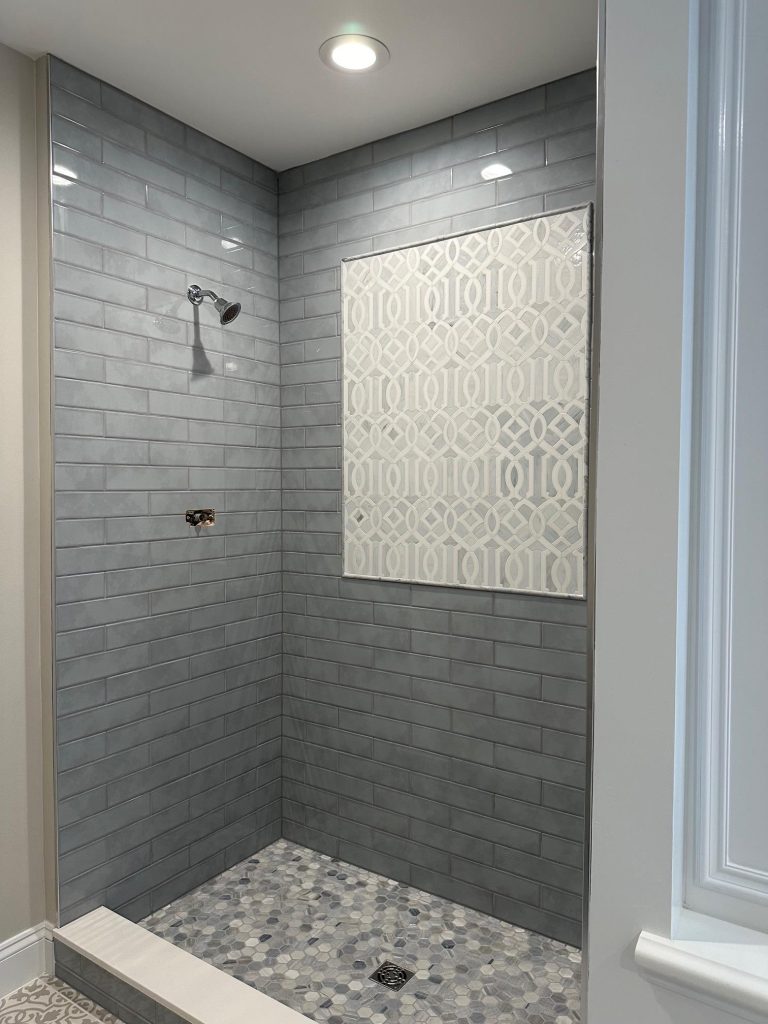 bath area with gray tiles