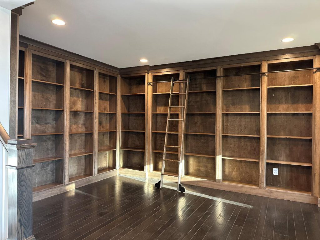 Empty wooden bookshelves with ladder