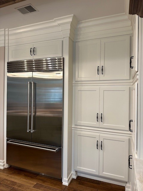 Modern kitchen with fridge and cabinets